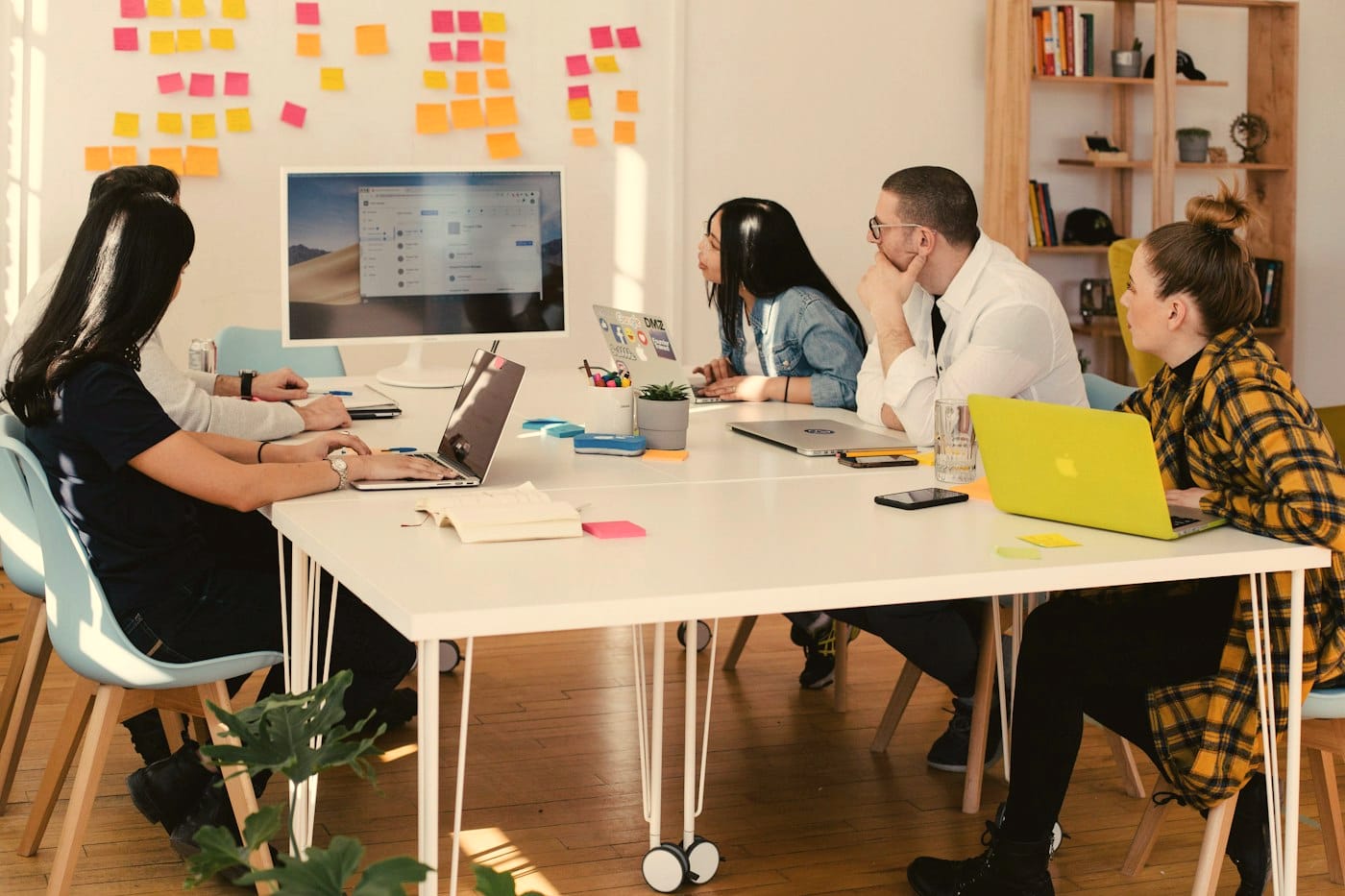 A company team working through documents at a shared table